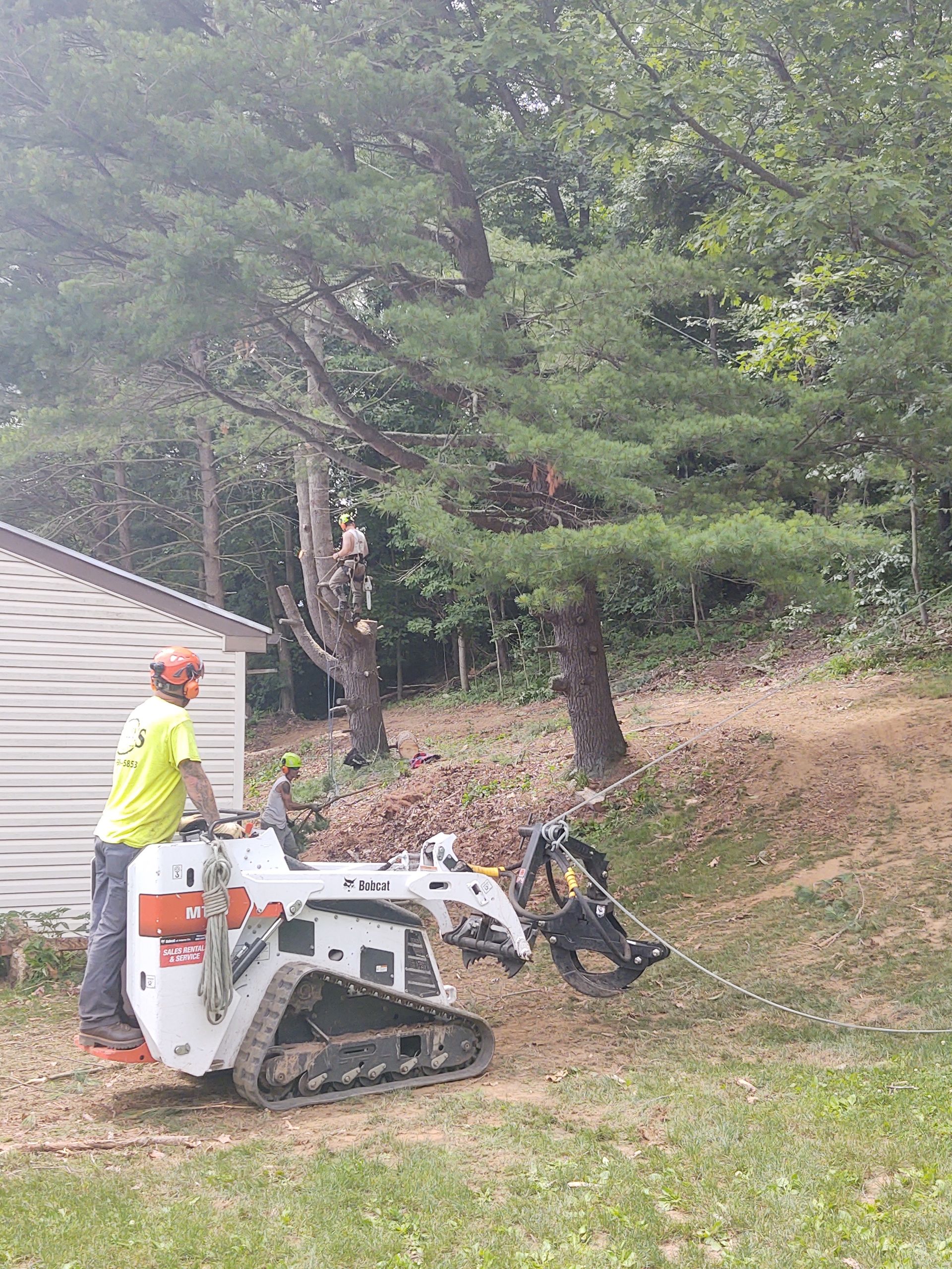 A man is standing next to a bulldozer in a yard